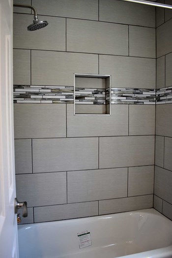 Shower and Tub , tiled walls, and built in shelf